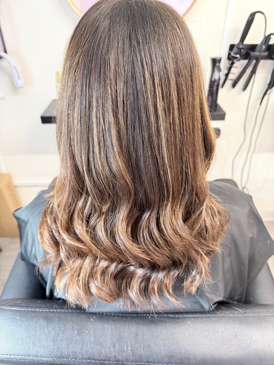 Brunette hair with caramel balayage, soft waves