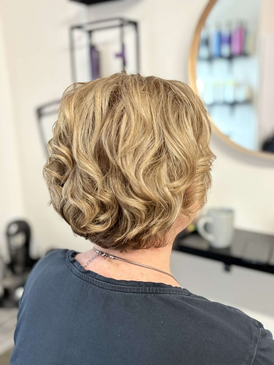Finished curly blonde style in the studio chair