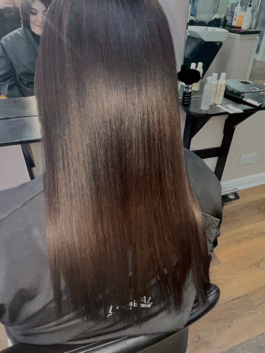 Mirror-sleek keratin blow dry result on long dark hair