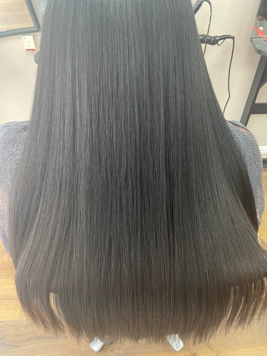 Long dark hair smoothed with a keratin blow dry